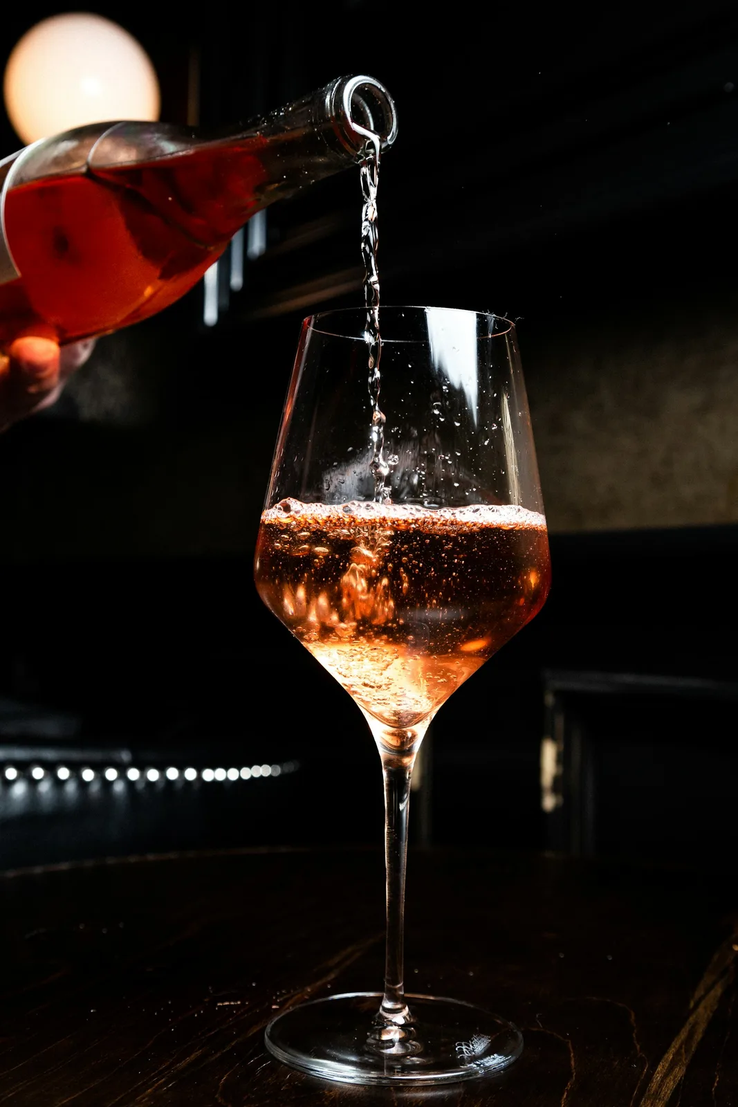 Amber natural wine being poured into a glass